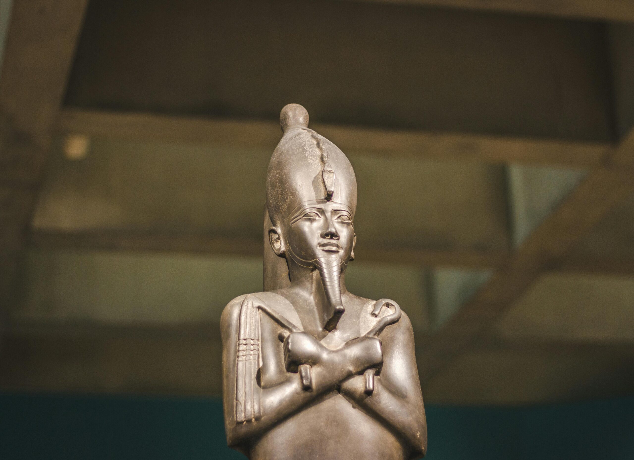 A detailed image of an ancient Egyptian statue displayed in a museum exhibit.