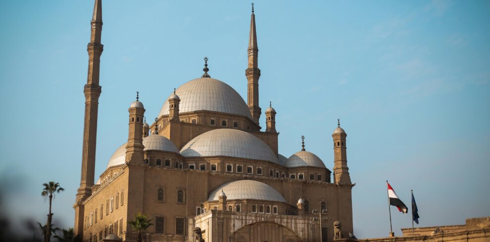 Explore the architectural beauty of the historic mosque in Cairo, featuring majestic domes and minarets.