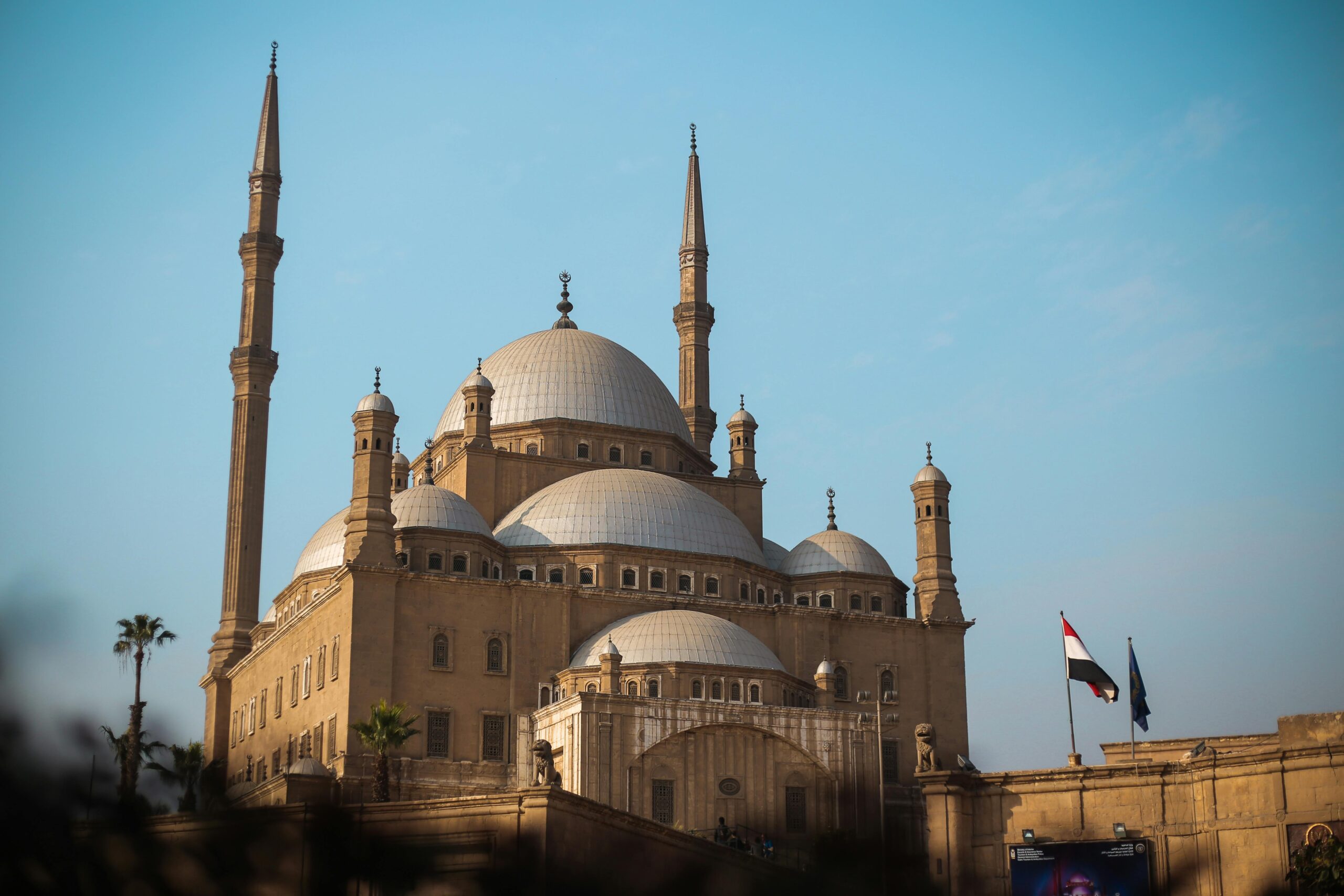 Explore the architectural beauty of the historic mosque in Cairo, featuring majestic domes and minarets.
